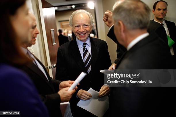 Sen. Joe Lieberman talks with fellow senators before a news conference at the U.S. Capitol March 10, 2011 in Washington, DC. In the same week that...