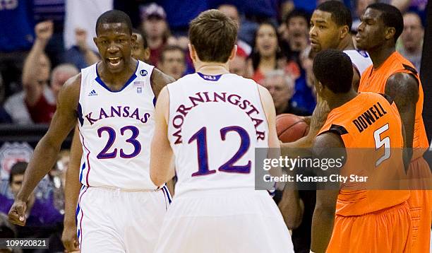 Kansas guard Mario Little is pumped after making a shot and being fouled on the play as Kansas guard Brady Morningstar applauds his effort while...