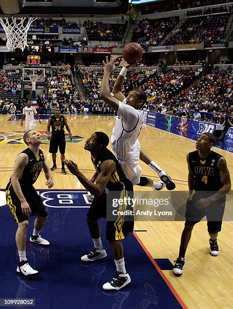 Adreian Payne of the Michigan State Spartans drives for a shot attempt against Melsahn Basabe of the Iowa Hawkeyes during the first round of the 2011...