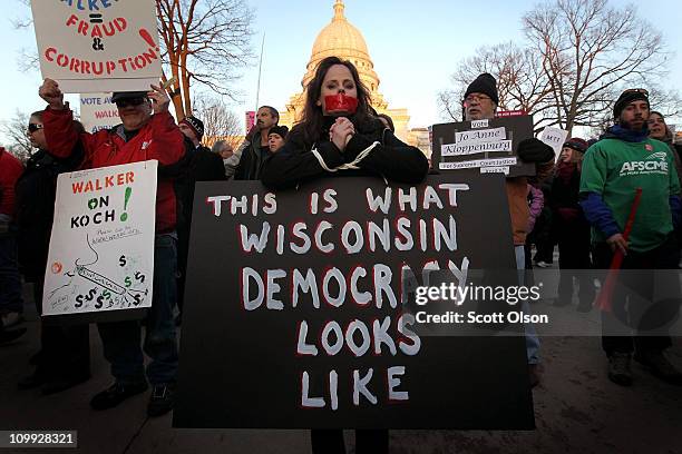 Protestors rally outside the State Capitol following the Wisconsin Assembly's vote which essentially eliminated collective bargaining rights for...