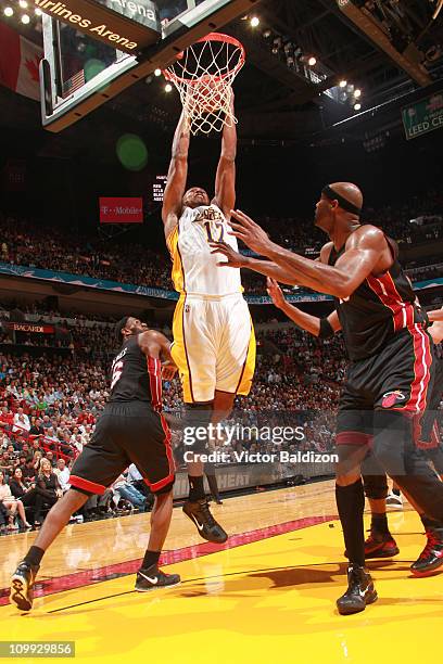 Andrew Bynum of the Los Angeles Lakers dunks against Erick Dampier of the Miami Heat on March 10, 2011 at American Airlines Arena in Miami, Florida....