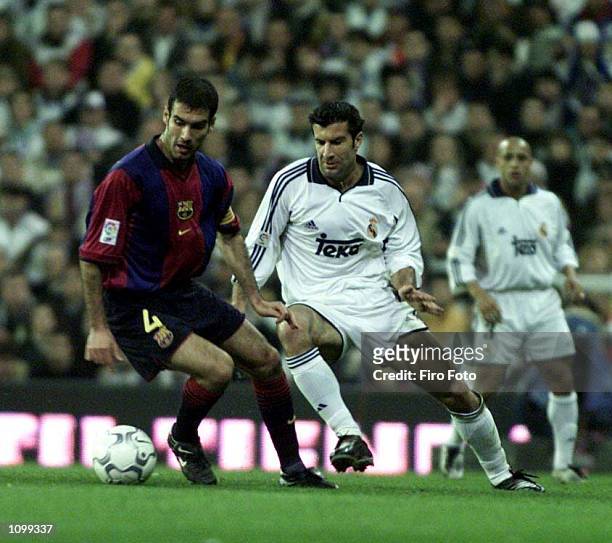 Josep Guardiola of Bacelona turns away from Lusi Figo of Real Madrid during the Real Madrid v FC Barcelona La Liga match played at the Santiago...