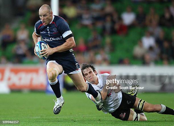 Stirling Mortlock of the Rebels makes a break during the round four Super Rugby match between the Melbourne Rebels and the Sharks at AAMI Park on...