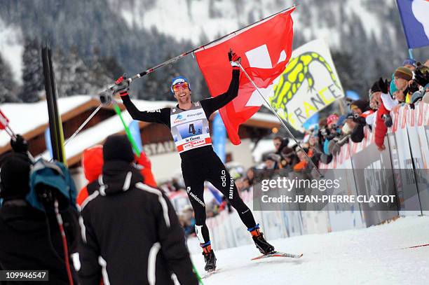 Switzerland's Curdin Perl celebrates at the end of the men's nordic skiing World Cup 4x10 km team event on December 19, 2010 in La Clusaz, French...