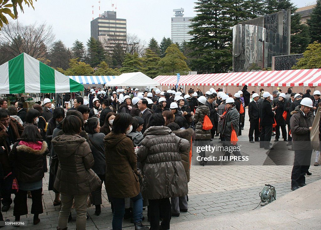 People evacuating gather at a park after