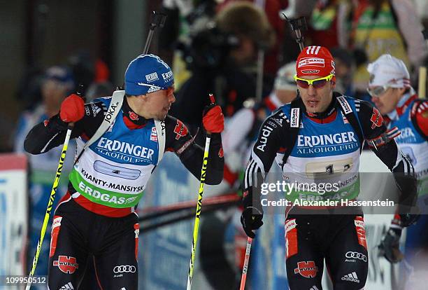 Arnd Peiffer of Germany hands over to his team mate Michael Greis during the men's relay during the IBU Biathlon World Championships at A.V....