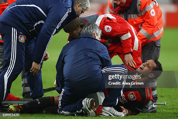 Renato Augusto of Leverkusen receives treatment during the UEFA Europa League round of 16 first leg match between Bayer Leverkusen and Villarreal at...