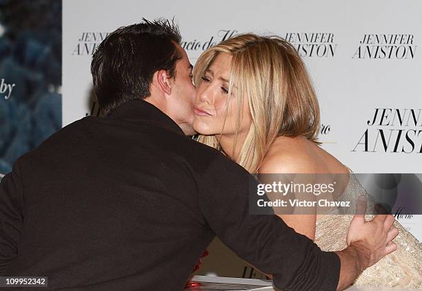 Actress Jennifer Aniston kisses a fan while she signs copies of her new perfume "Jennifer Aniston" at Palacio De Hierro Polanco on March 10, 2011 in...