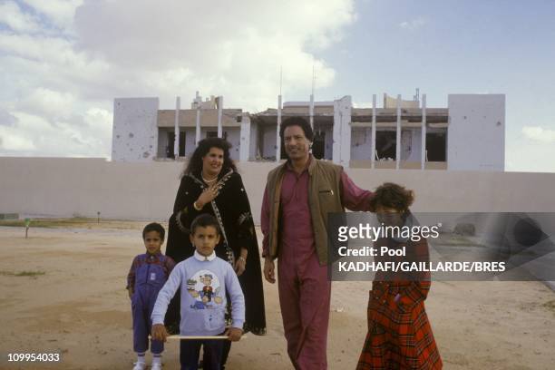 Colonel Muammar Gaddafi with his wife Safia and daughter Aicha near Bab Azizia palace, destroyed in a US air raid and left in ruins, November 1986.