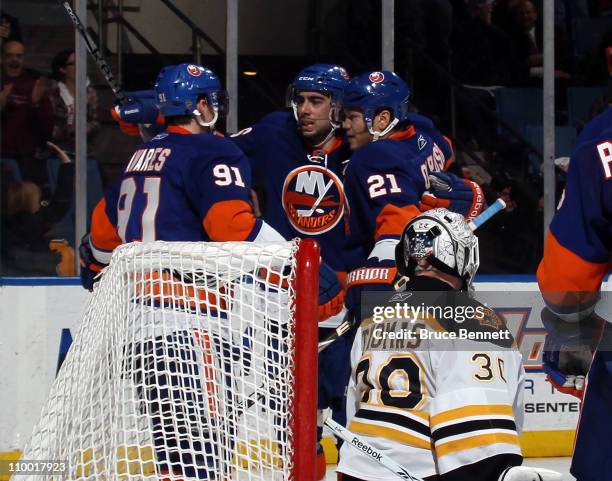 John Tavares, Matt Moulson and Kyle Okposo of the New York Islanders celebrate Moulson's goal at 19:58 of the second period against Tim Thomas of the...