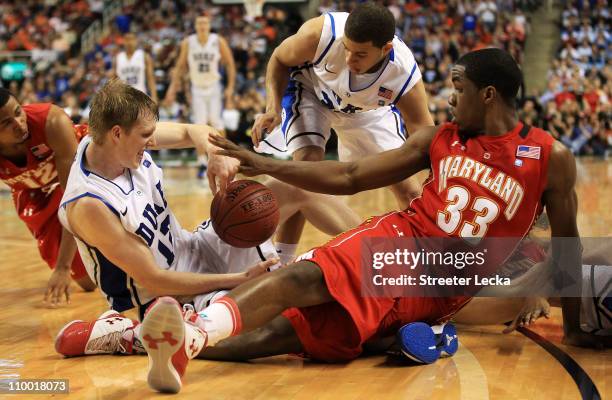 Kyle Singler of the Duke Blue Devils and Dino Gregory of the Maryland Terrapins battle for possession of the ball during the second half in the...