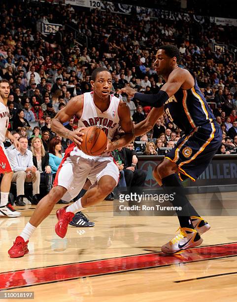 DeMar DeRozan of the Toronto Raptors drives against Danny Granger of the Indiana Pacers on March 11, 2011 at the Air Canada Centre in Toronto,...