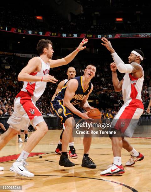 Tyler Hansbrough of the Indiana Pacers looks to shoot against Andrea Bargnani and James Johnson of the Toronto Raptors on March 11, 2011 at the Air...