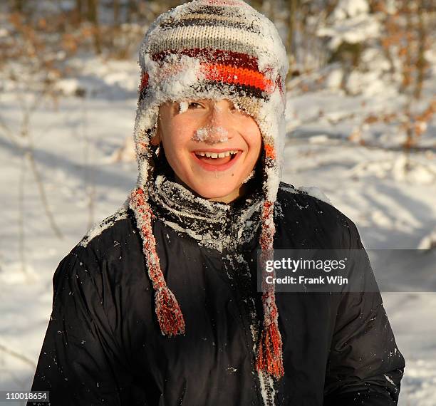 boy with snowy face and hat - wijn stock pictures, royalty-free photos & images