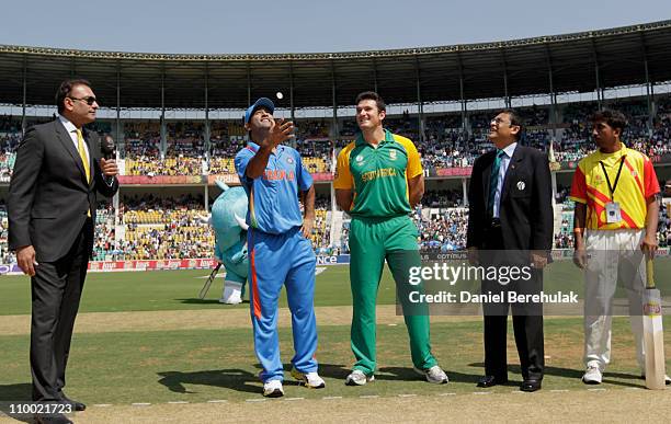 Captain MS Dhoni of India takes the coin toss as captain Graeme Smitth of South Africa looks on during the Group B ICC World Cup Cricket match...