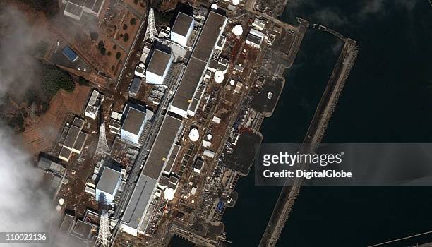 In this satellite view, Fukushima Dai-Ichi Nuclear Power plant is damaged by an earthquake which caused a tsunami, March 12, 2011 in Okuma, Japan. An...