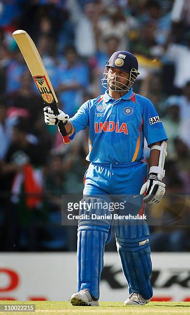 Sachin Tendulkar of India raises his bat on scoring his half century during the Group B ICC World Cup Cricket match between India and South Africa at...