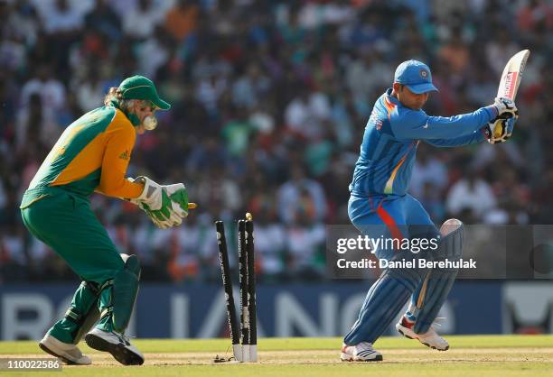 Virender Sehwag of India is bowled by Faf du Plessis of South Africa during the Group B ICC World Cup Cricket match between India and South Africa at...