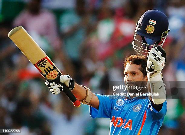 Sachin Tendulkar of India raises his bat on scoring his century during the Group B ICC World Cup Cricket match between India and South Africa at...