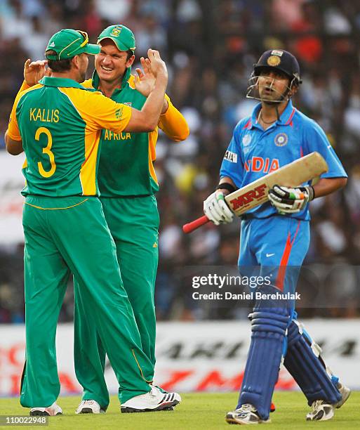 Jacques Kallis of South Africa celebrates with team mate Graeme Smith after taking the catch to dismiss Gautam Gambhir of India during the Group B...