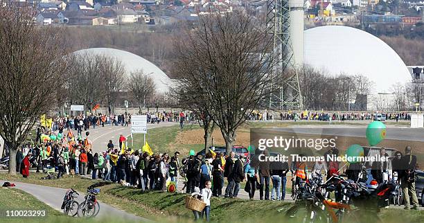 Anti-nuclear activists hold hands in a human chain they projected as 45km long in front of the Neckarwestheim nuclear power plant on March 12, 2011...