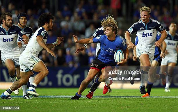 Nick Cummins of the Force looks to avoid being tackled by Rene Ranger of the Blues during the round four Super Rugby match between the Western Force...