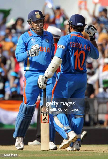 Virender Sehwag of India celebrates with team mate Sachin Tendulkar during the Group B ICC World Cup Cricket match between India and South Africa at...