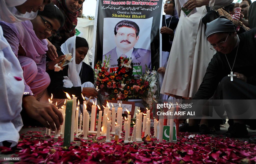 Pakistani nuns light candle during a ral