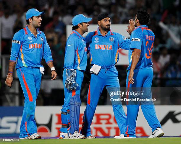 Dhoni of India celebrates with team mates after the run out of Jacques Kallis of South Africa off a throw from Harbhajan Singh of India during the...