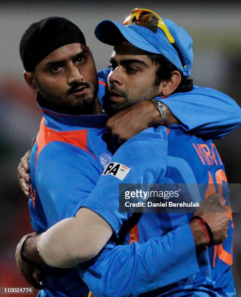 Harbhajan Singh of India celebrates with team mate Virat Kohli after taking the wicket of AB de Villiers of South Africa during the Group B ICC World...