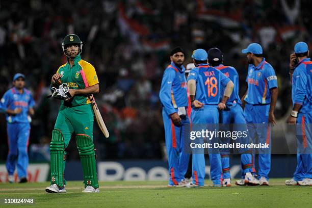 Duminy of South Africa walks back to the pavillion after being stumped by MS Dhoni off the bowling of Harbhajan Singh of India during the Group B ICC...