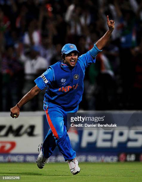 Substitute fieldsman Suresh Raina of India celebrates after taking the catch to dismiss Johan Both of South Africa off the bowling of MunafPatel of...