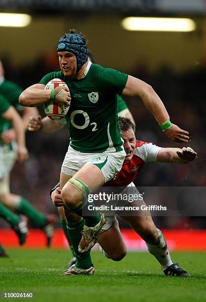 Sean OBrien of Ireland is tackled by Matthew Rees of Wales during the RBS Six Nations Championship match between Wales and Ireland at the Millennium...