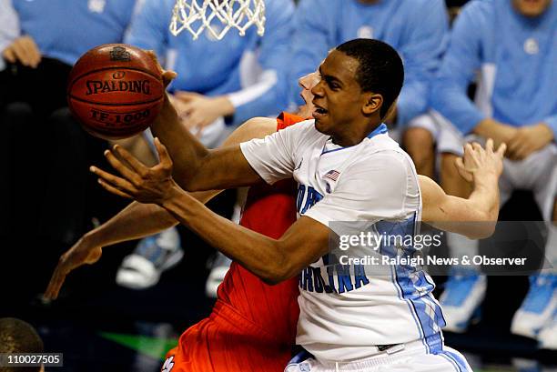 North CArolina forward John Henson grabs a rebound over Clemson guard Tanner Smith during the second half in the semifinals of the ACC Tournament at...