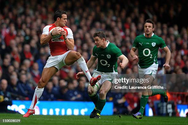 Lee Byrne of Wales takes a high ball as Brian O'Driscoll and Tommy Bowe of Ireland close in during the RBS Six Nations Championship match between...