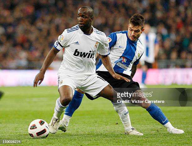 Lass Diarra of Real Madrid is chased by Tiago Figueires of Hercules during the La Liga match between Real Madrid and Hercules at Estadio Santiago...