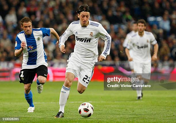 Mesut Ozil of Real Madrid runs with the ball during the La Liga match between Real Madrid and Hercules at Estadio Santiago Bernabeu on March 12, 2011...