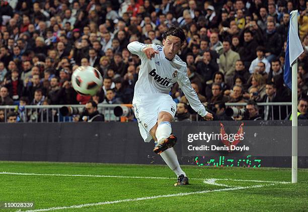 Mesut Ozil of Real Madrid takes a corner kick during the La Liga match between Real Madrid and Hercules CF at Estadio Santiago Bernabeu on March 12,...