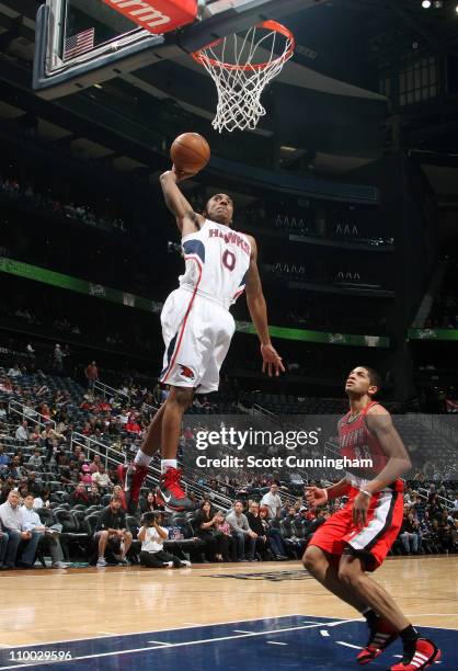 Jeff Teague of the Atlanta Hawks dunks against Nicolas Batum of the Portland Trail Blazers on March 12, 2011 at Philips Arena in Atlanta, Georgia....