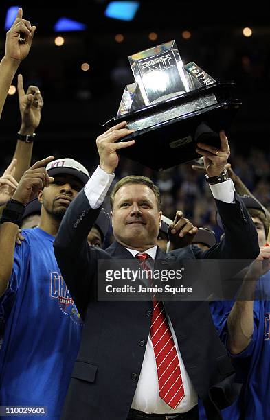 Markieff Morris and head coach Bill Self of the Kansas Jayhawks celebrate with the Big 12 championship trophy after defeating the Texas Longhorns...