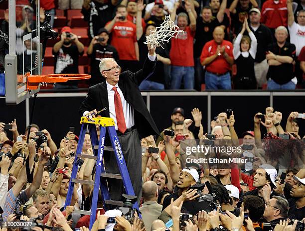 Head coach Steve Fisher of the San Diego State Aztecs waves a net after cutting it down following the team's 72-54 victory over the Brigham Young...