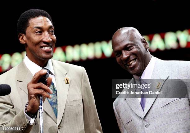 Former players Scottie Pippen and Michael Jordan of the Chicago Bulls smile as the crowd cheers during a 20th anniversary recognition ceremony of the...