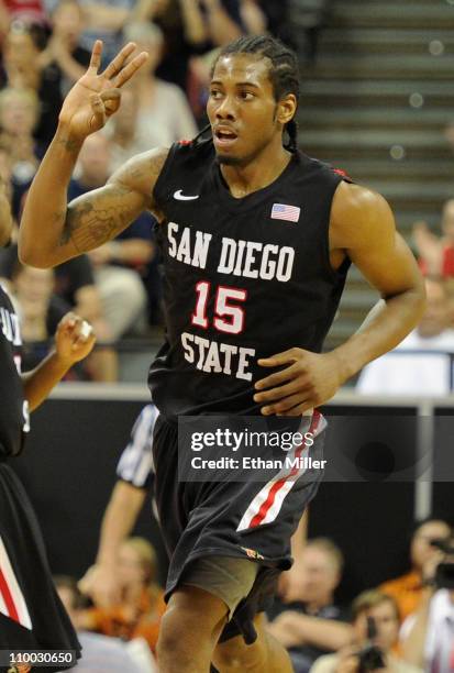 Kawhi Leonard of the San Diego State Aztecs holds up three fingers after scoring a three-point basket against the Brigham Young University Cougars...