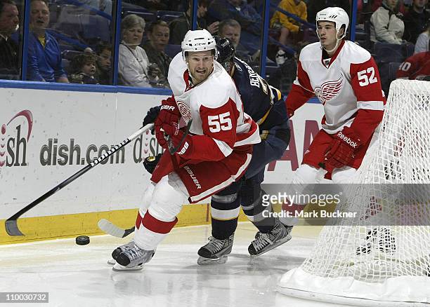 Patrik Berglund of the St. Louis Blues controls the puck in between Niklas Kronwall and Jonathan Ericsson of the Detroit Red Wings in an NHL game on...