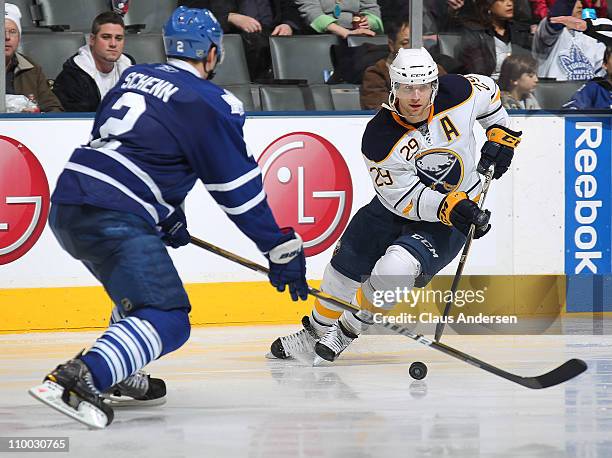 Jason Pominville of the Buffalo Sabres skates with puck around Luke Schenn of the Toronto Maple Leafs in a game on March 12, 2011 at the Air Canada...