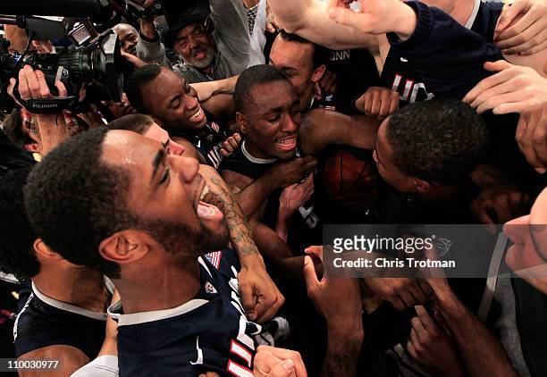 Kemba Walker of the Connecticut Huskies celebrates with teammates after defeating the Louisville Cardinals during the championship of the 2011 Big...