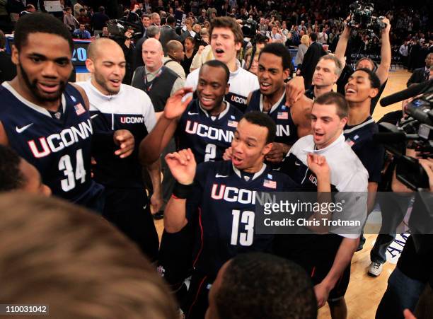 Shabazz Napier of the Connecticut Huskies celebrates with teammates after defeating the Louisville Cardinals during the championship of the 2011 Big...