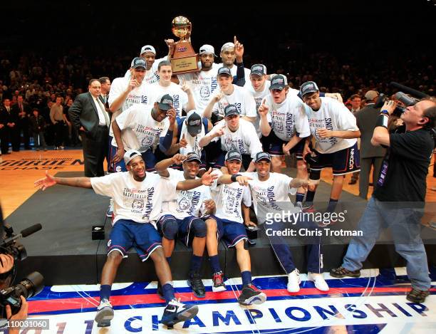 The Connecticut Huskies celebrate with their trophy after defeating the Louisville Cardinals during the championship of the 2011 Big East Men's...