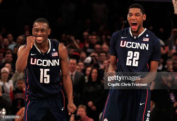 Kemba Walker and Roscoe Smith of the Connecticut Huskies celebrate late in the game against the Louisville Cardinals during the championship of the...