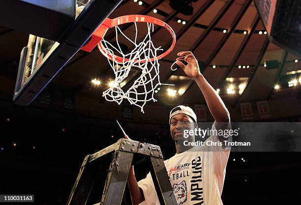 Kemba Walker of the Connecticut Huskies cuts down the net after defeating the Louisville Cardinals during the championship of the 2011 Big East Men's...